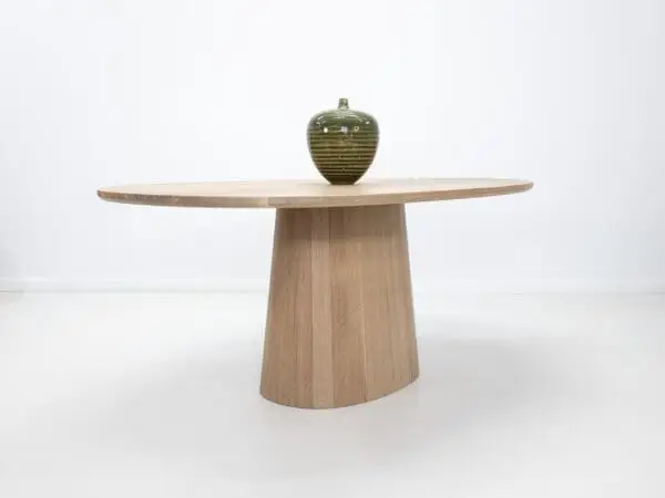 Our CATE, pedestal base, dining table with decor on top.