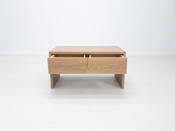 A coffee table with two open drawers.