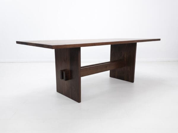 A walnut trestle table with double stretchers.