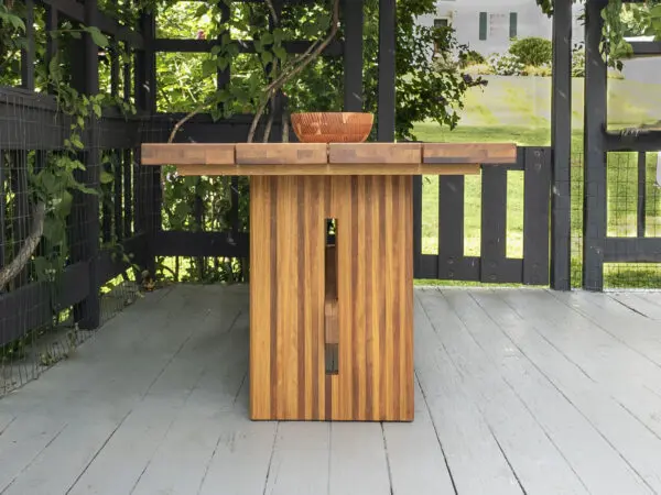 Wooden outdoor table on a deck.