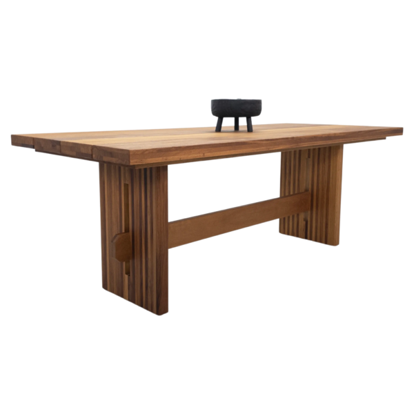 Wooden dining table with slatted legs.