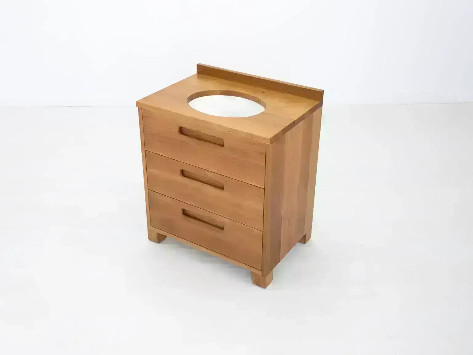 Modern white oak bathroom vanity featuring dovetail joinery and recessed pulls