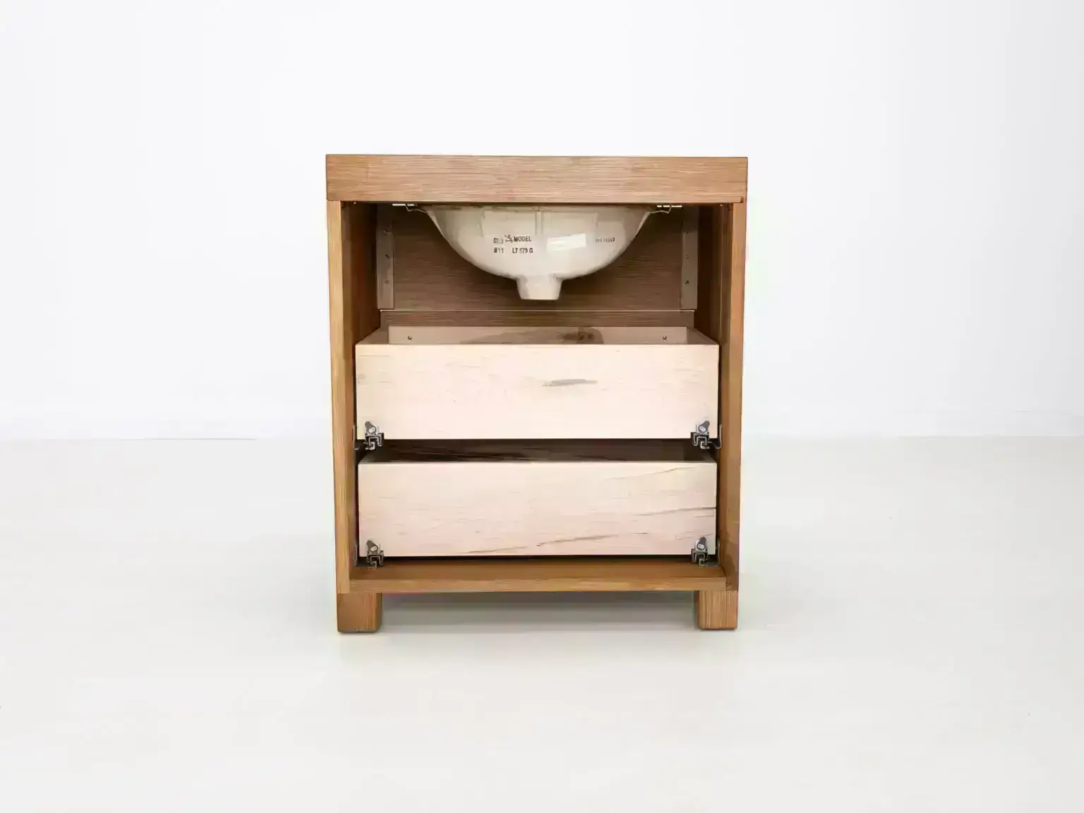 Modern white oak bathroom vanity featuring dovetail joinery and recessed pulls