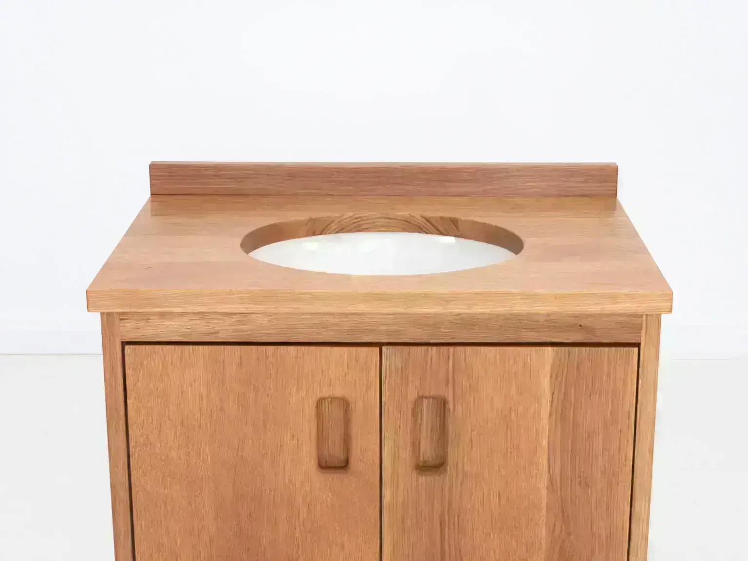 Custom rift sawn white oak vanity with solid wood top and soft close hardware