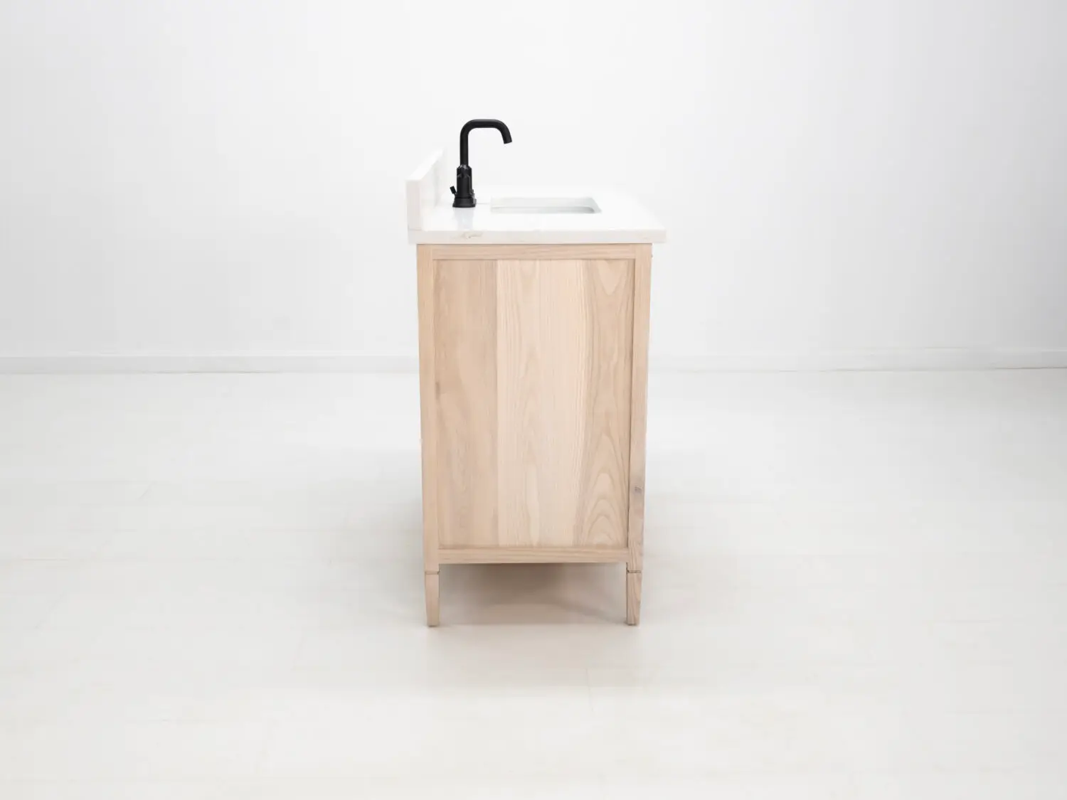 Light ashwood vanity featuring a faux top drawer face and additional storage