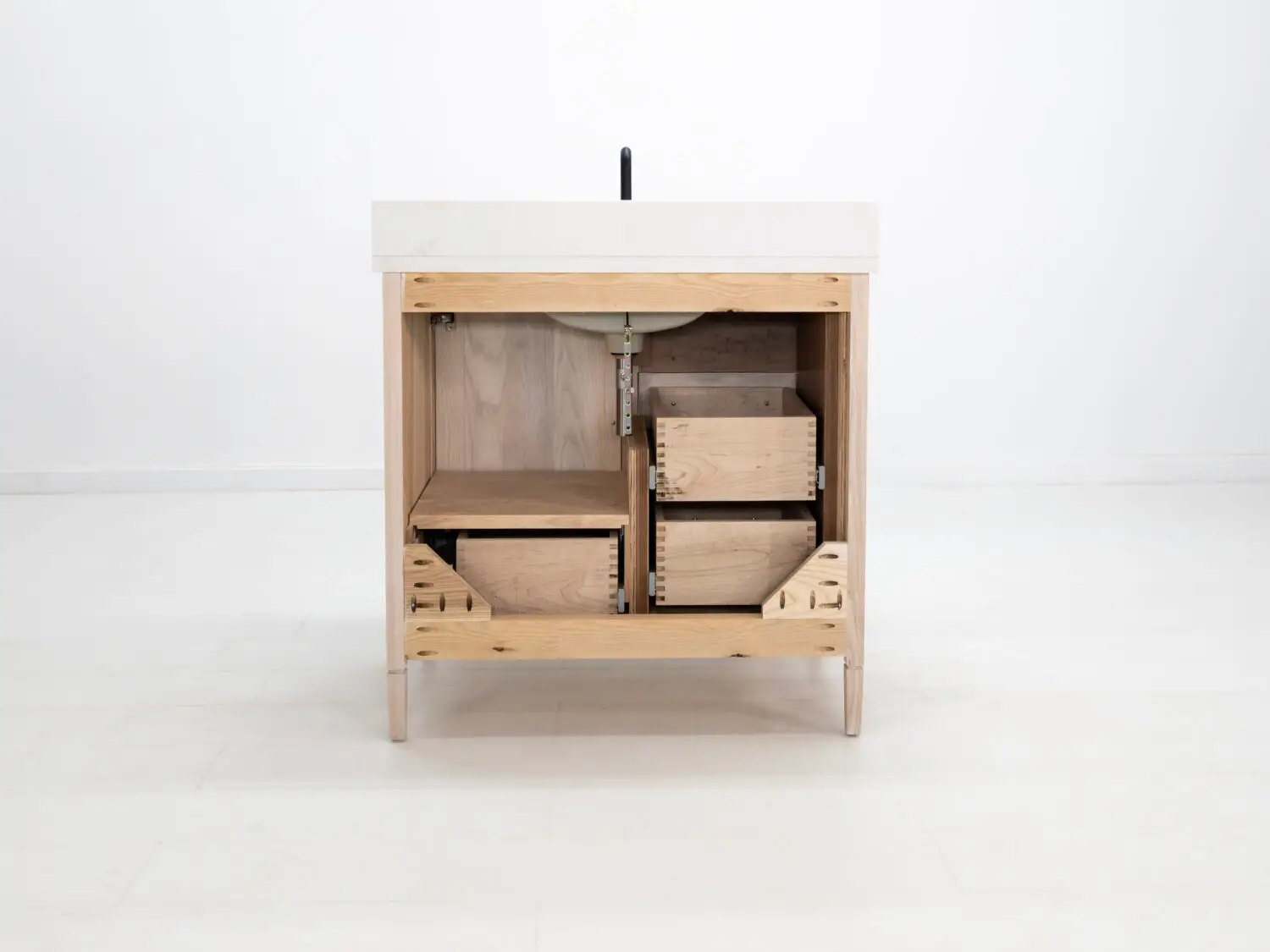 Custom solid wood bathroom vanity with black hardware and a refined design