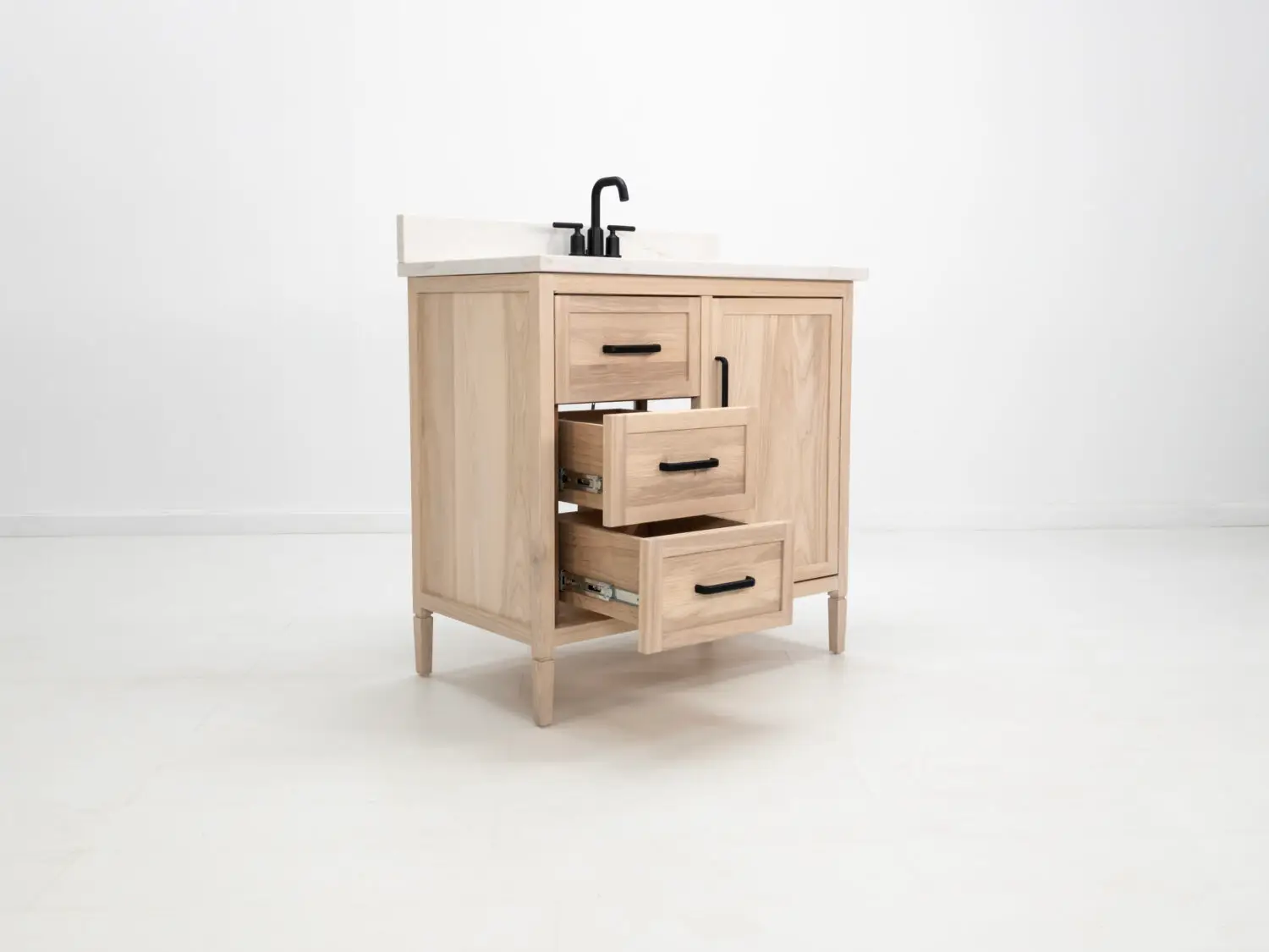 Light ashwood vanity featuring a faux top drawer face and additional storage