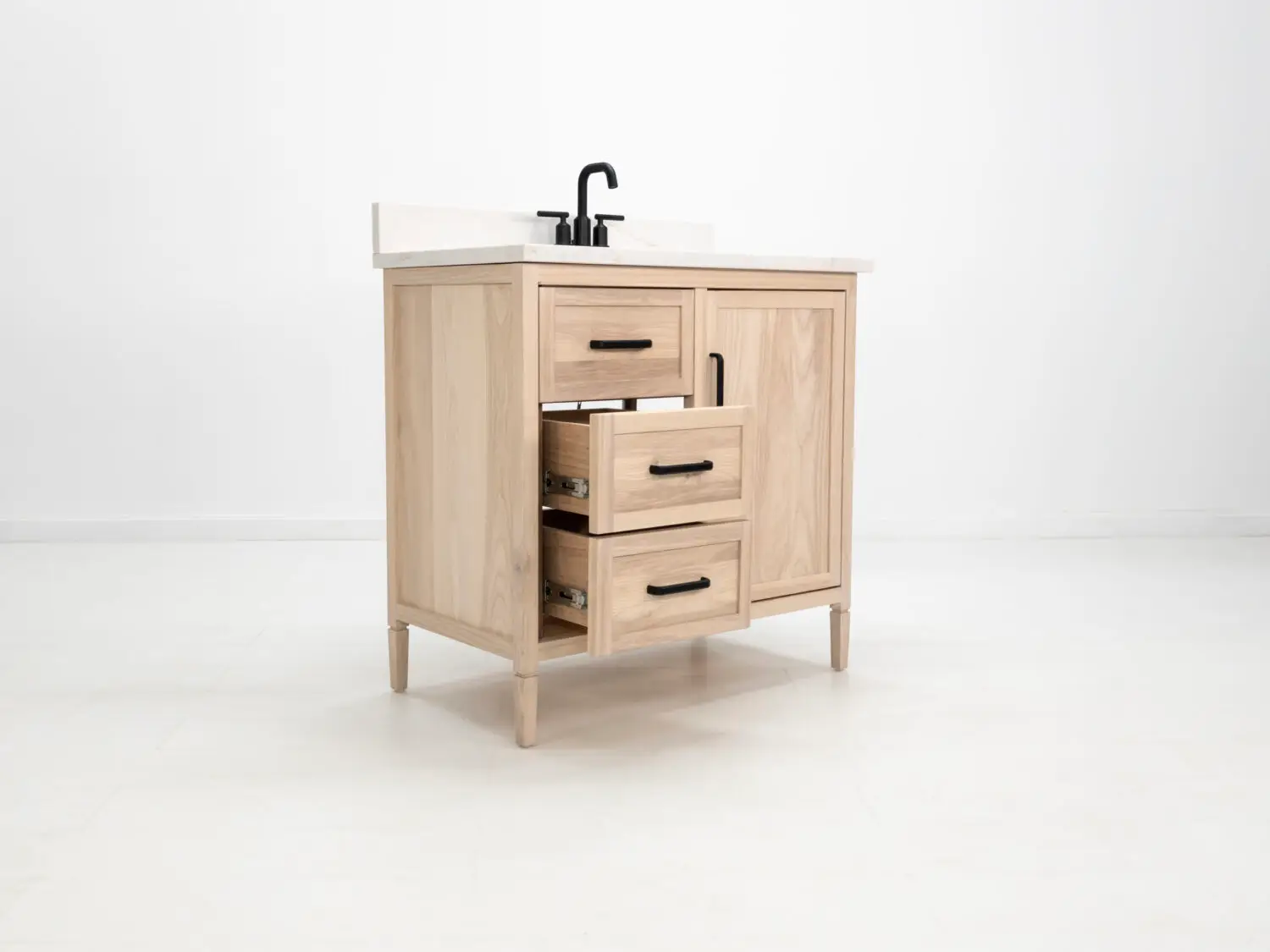 Light ashwood vanity featuring a faux top drawer face and additional storage