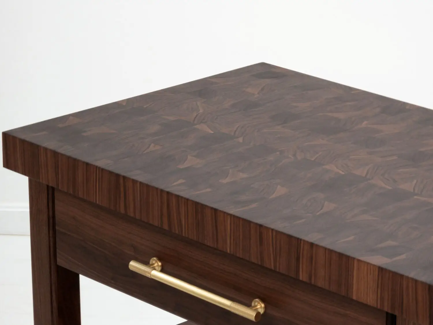 Close up of the 25 inch thick end grain walnut butcher block top showcasing its natural grain and knife friendly surface