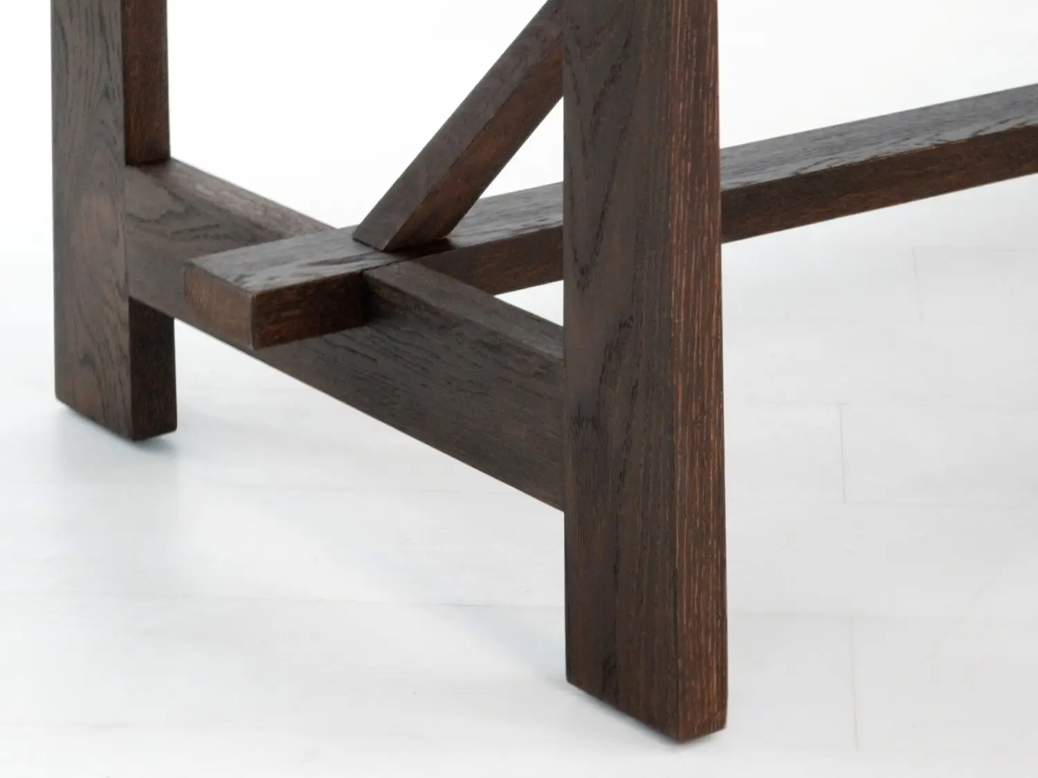 Close up of the table base  Detailed view of the trestle base showcasing expert joinery and sturdy design