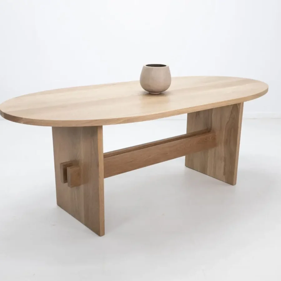 Wooden oval table with unique legs.